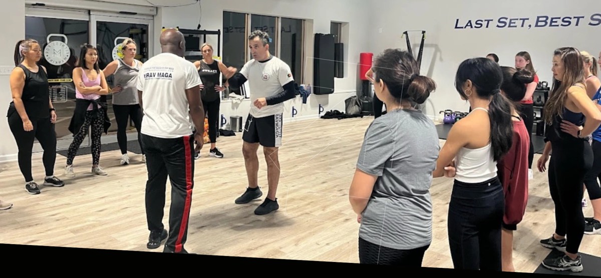 Instructor demonstrating a self-defense technique to a class at SD4ALL, Cedar Knolls NJ